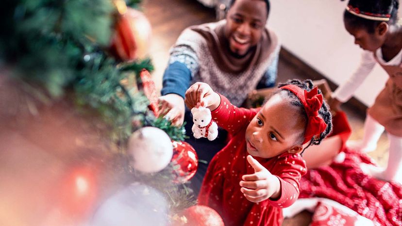 girl decorating Christmas tree